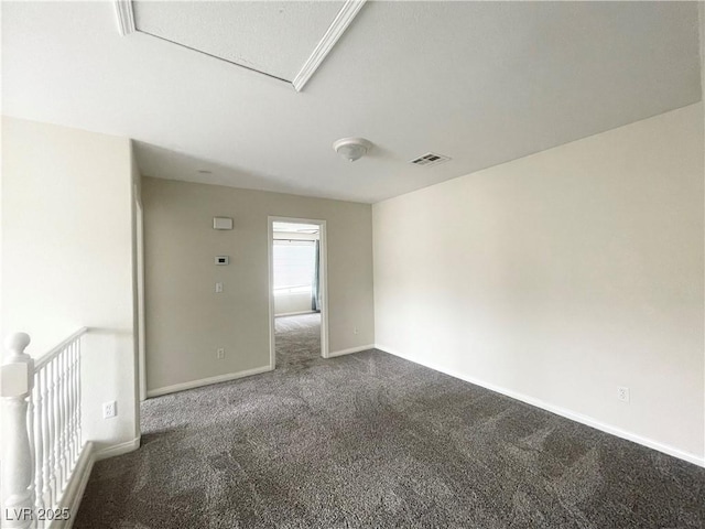 carpeted empty room with visible vents and baseboards