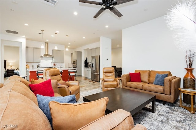 living room featuring recessed lighting, a ceiling fan, and visible vents