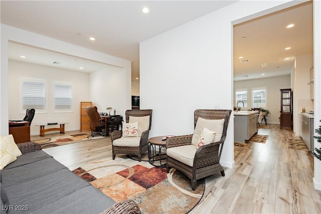 living room with recessed lighting and light wood-type flooring