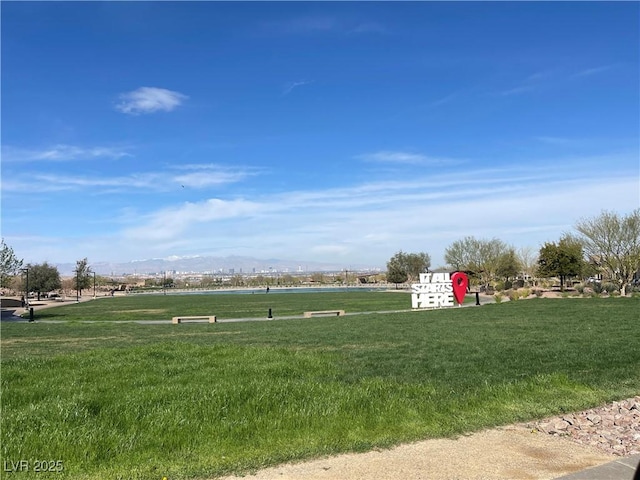 view of property's community with a lawn