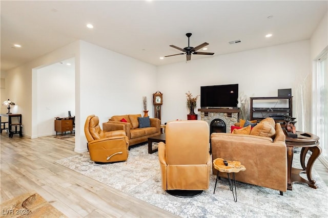 living area featuring a ceiling fan, recessed lighting, wood finished floors, and visible vents