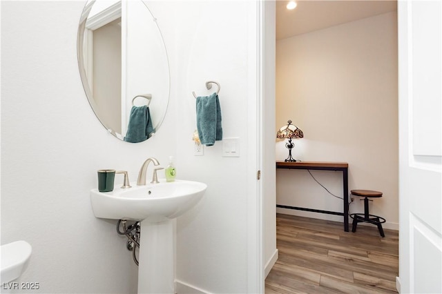 bathroom featuring baseboards and wood finished floors