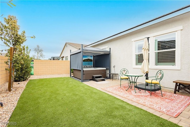 view of yard featuring a patio, a fenced backyard, and a hot tub