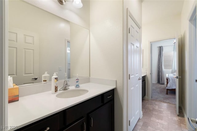 bathroom featuring vanity and stone finish flooring