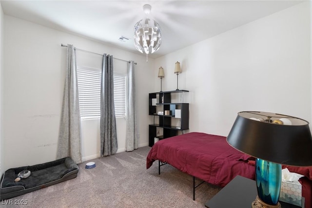 bedroom with a notable chandelier, baseboards, and carpet