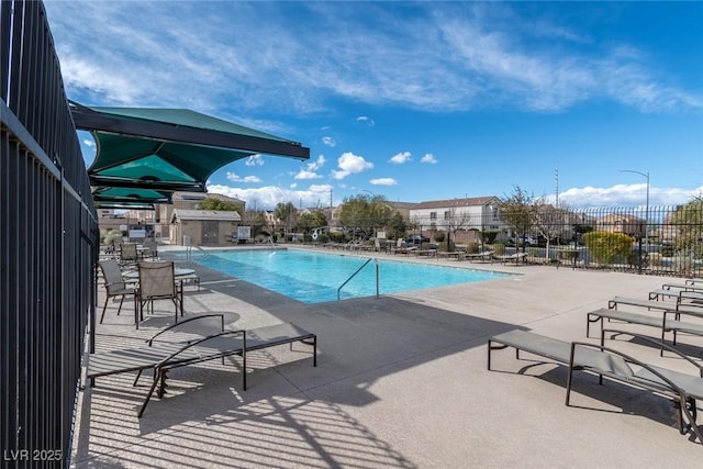 pool featuring a patio and fence