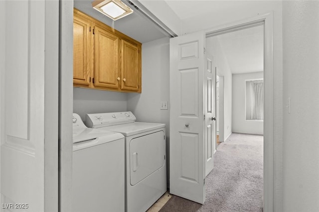 laundry area with cabinet space, light colored carpet, and washing machine and clothes dryer