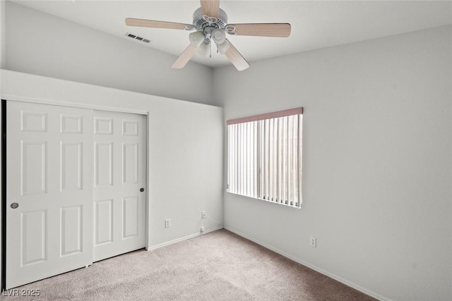 unfurnished bedroom with a closet, visible vents, baseboards, and carpet floors