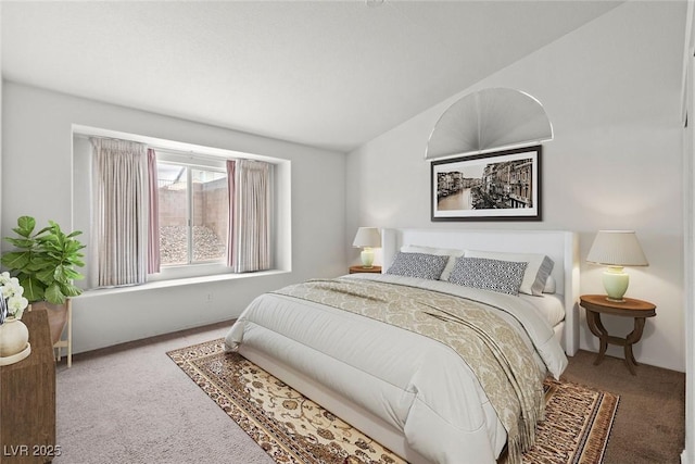 bedroom with carpet flooring and vaulted ceiling