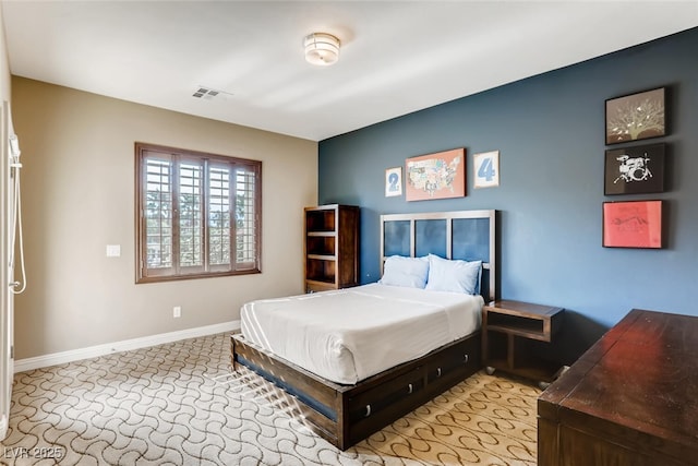 bedroom featuring light carpet, visible vents, and baseboards