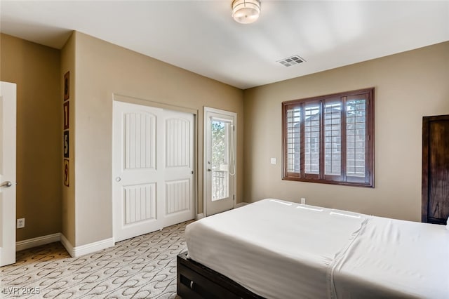 bedroom featuring access to exterior, baseboards, visible vents, and a closet