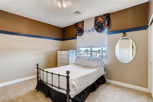 carpeted bedroom featuring baseboards and visible vents