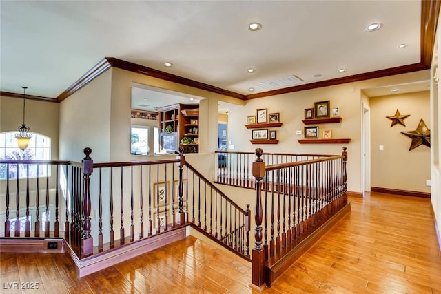 stairs with recessed lighting, ornamental molding, baseboards, and hardwood / wood-style flooring