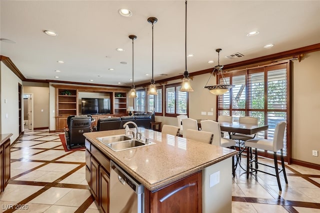 kitchen with a sink, baseboards, stainless steel dishwasher, and recessed lighting