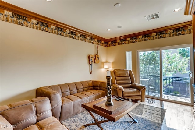 living room with crown molding, recessed lighting, wood finished floors, and visible vents