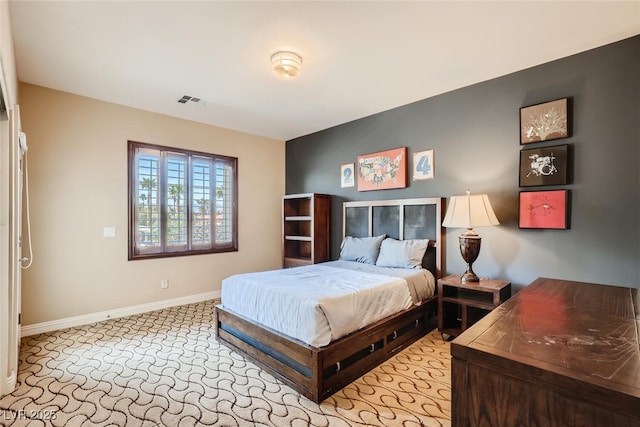 bedroom featuring light carpet, visible vents, and baseboards