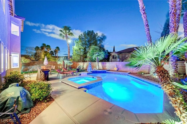 view of swimming pool featuring a patio, a fenced backyard, and a pool with connected hot tub