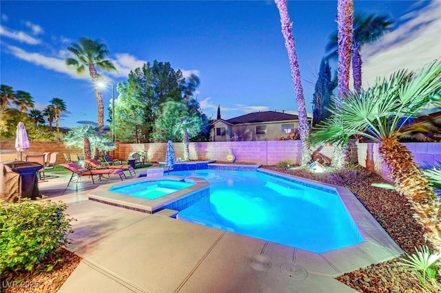 view of swimming pool featuring a fenced backyard, a fire pit, a pool with connected hot tub, and a patio