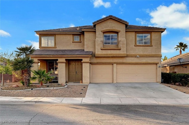 view of front of property with an attached garage, driveway, and stucco siding