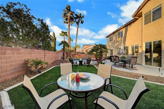 view of patio / terrace featuring outdoor dining space and a fenced backyard