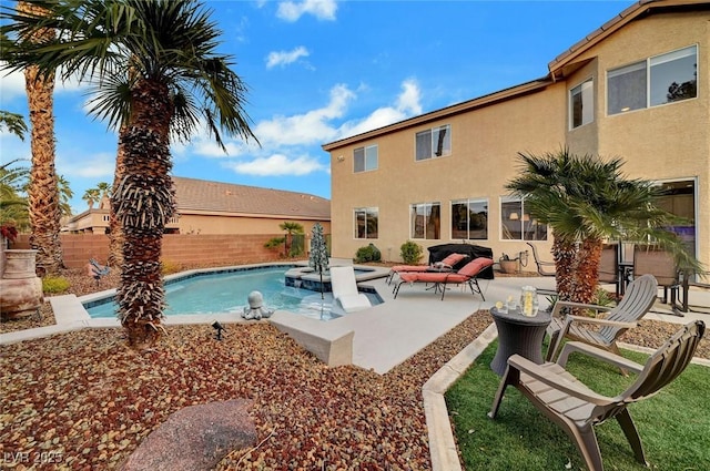 view of swimming pool with fence, a pool with connected hot tub, and a patio area