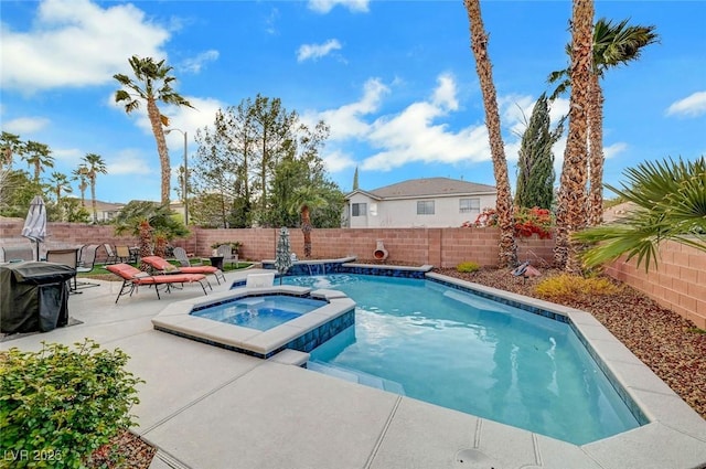 view of swimming pool featuring a patio, a fenced backyard, and a pool with connected hot tub