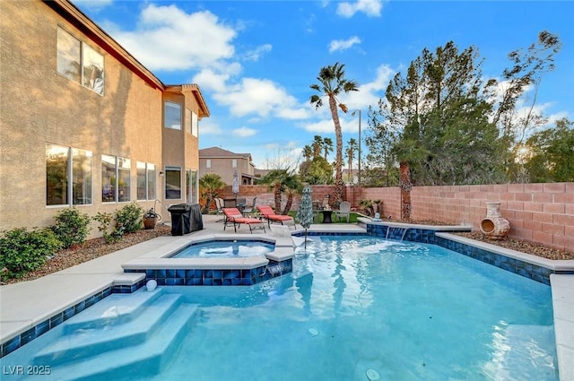 view of swimming pool with a patio area, a fenced backyard, and a pool with connected hot tub