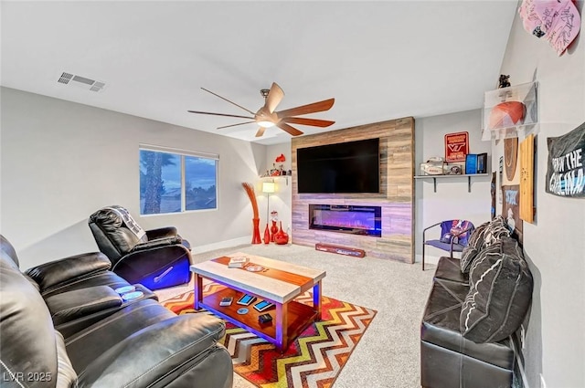 living area featuring a ceiling fan, visible vents, carpet floors, and baseboards