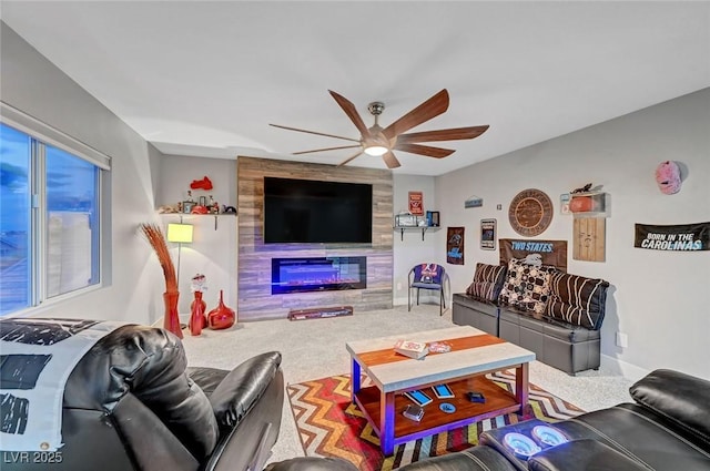 living room featuring a ceiling fan, a tiled fireplace, carpet, and baseboards