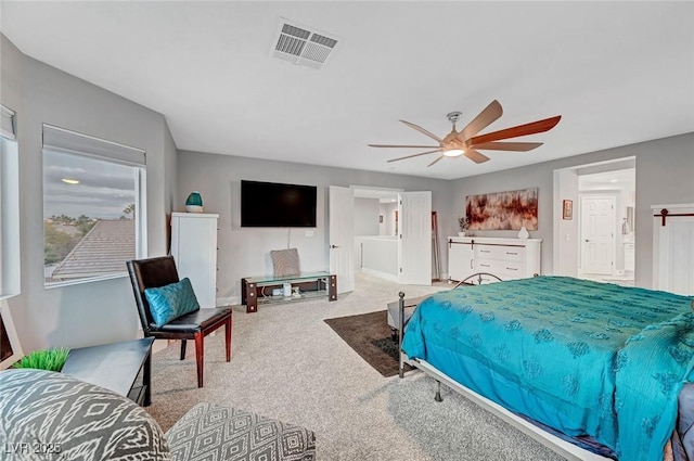 carpeted bedroom with visible vents and a ceiling fan