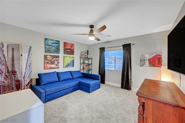 living room featuring visible vents, light colored carpet, baseboards, and ceiling fan