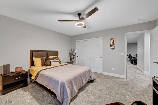 carpeted bedroom featuring a closet, baseboards, and ceiling fan