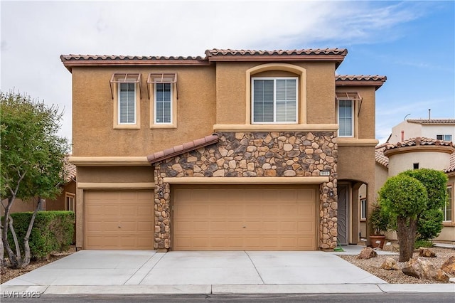 mediterranean / spanish house with a tile roof, an attached garage, driveway, and stucco siding