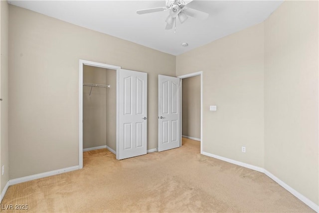 unfurnished bedroom with light carpet, ceiling fan, a closet, and baseboards