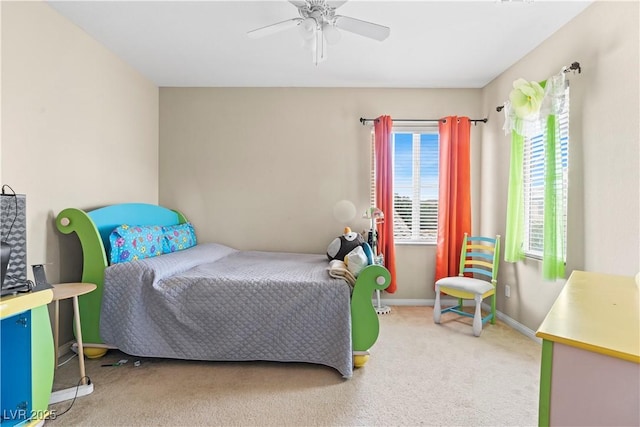 carpeted bedroom featuring a ceiling fan and baseboards