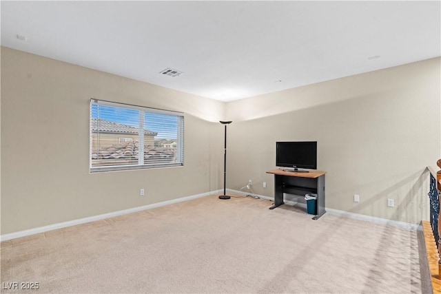 unfurnished living room featuring visible vents, light carpet, and baseboards