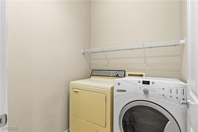 laundry area featuring separate washer and dryer and laundry area