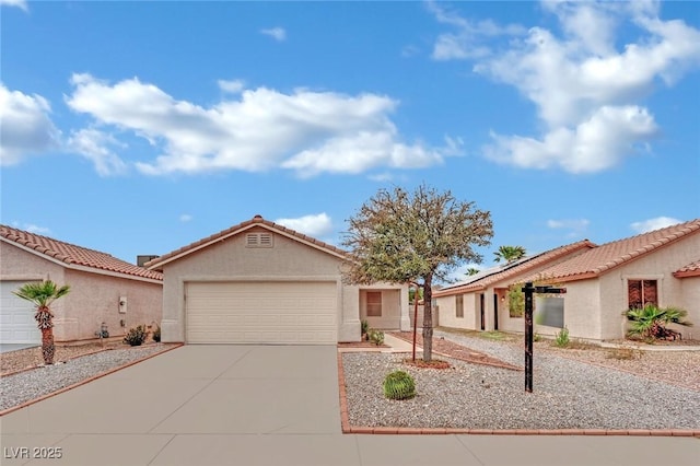 view of front facade featuring stucco siding, driveway, a tile roof, a garage, and solar panels