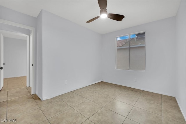 empty room featuring light tile patterned flooring, baseboards, and ceiling fan