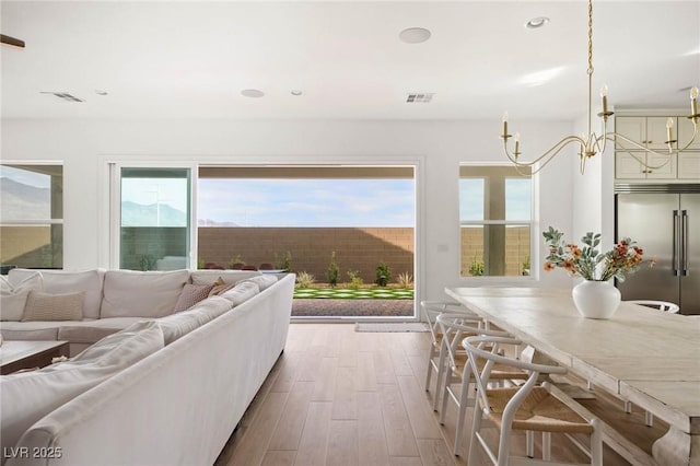 living room featuring recessed lighting, visible vents, and wood finished floors