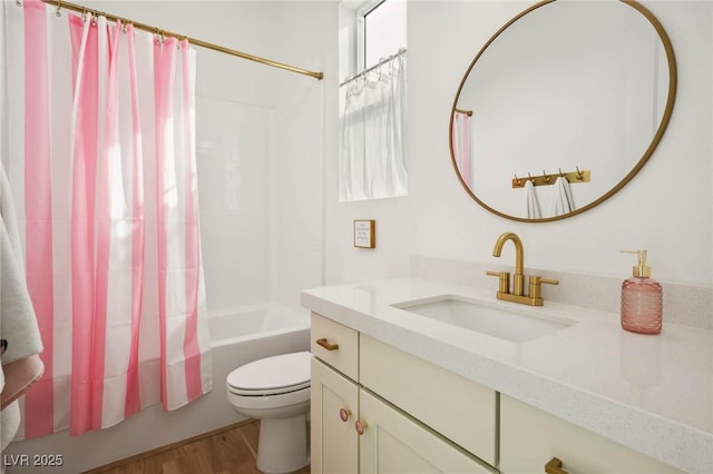 bathroom with shower / tub combo with curtain, toilet, vanity, and wood finished floors