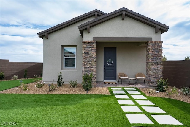 exterior space featuring stucco siding, a yard, and fence