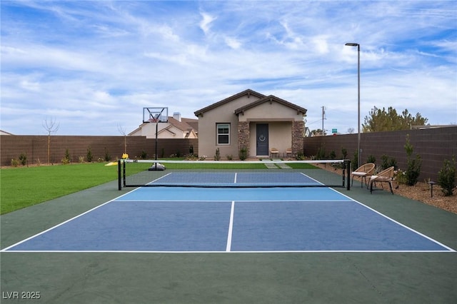 view of sport court featuring basketball court and fence