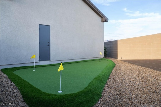 view of community with a fenced backyard