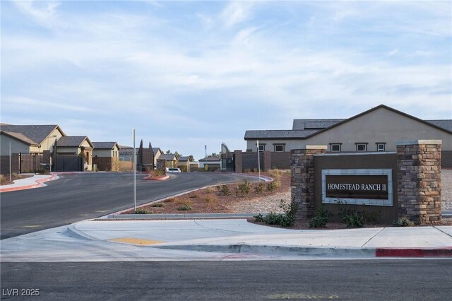 view of street featuring curbs, a residential view, and sidewalks