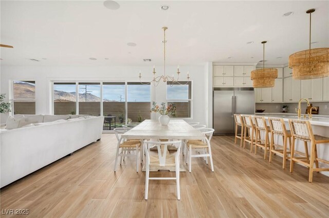 dining space with recessed lighting and light wood-style floors