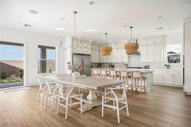 dining room with recessed lighting, visible vents, and light wood-style flooring