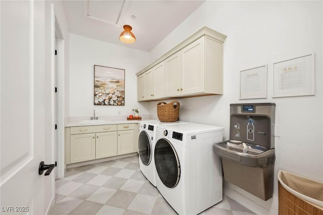 laundry area with independent washer and dryer, a sink, cabinet space, light floors, and attic access