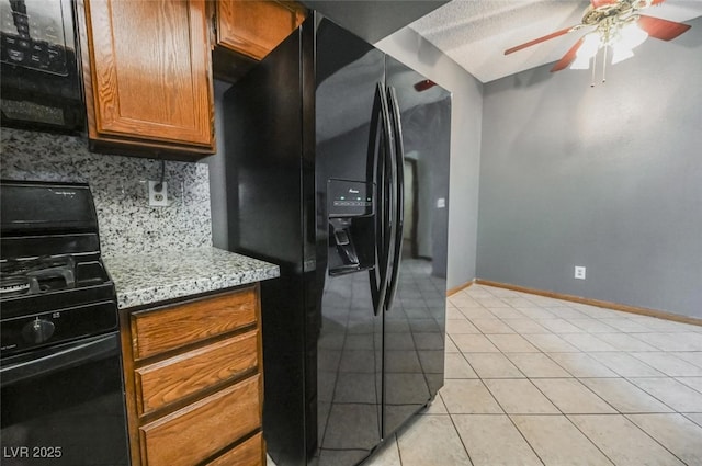 kitchen featuring light tile patterned floors, a ceiling fan, black appliances, brown cabinets, and backsplash