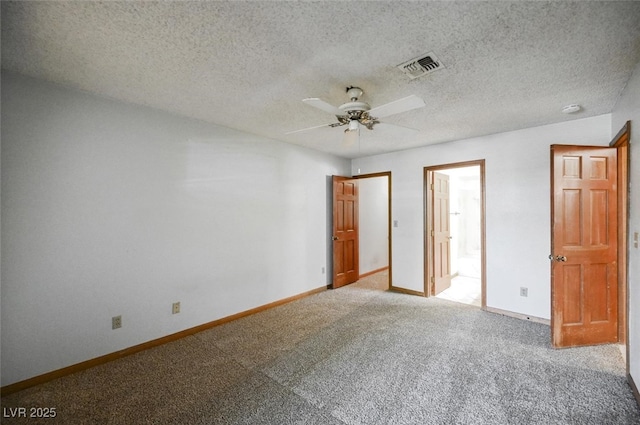 unfurnished bedroom featuring visible vents, baseboards, carpet floors, a textured ceiling, and a ceiling fan